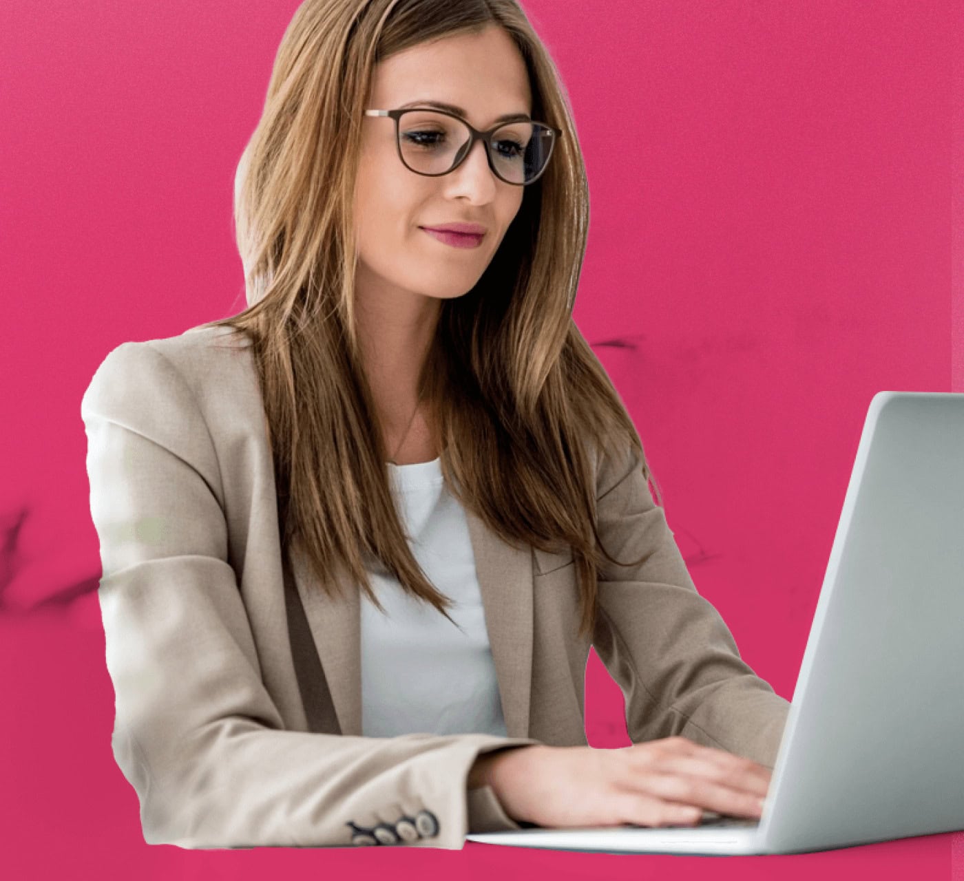 A woman typing on her laptop with a pink background