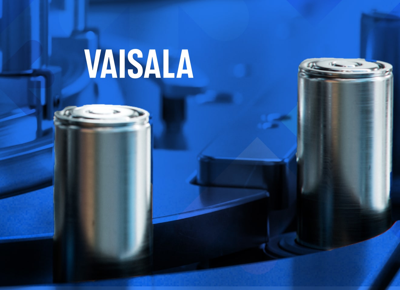 Assembly line of metal cylinders being manufactured on a blue background.