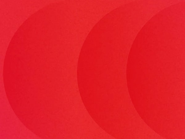 Red half circle shapes moving to the left on a red background