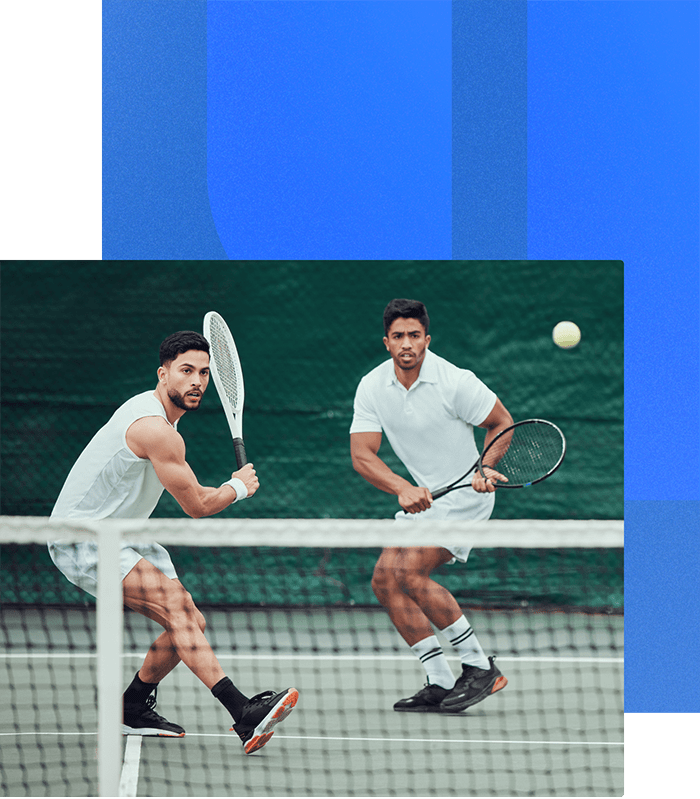 Two athletic men wearing white clothes playing tennis