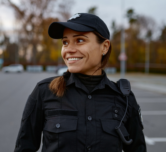 a police officer smiling in a parking lot