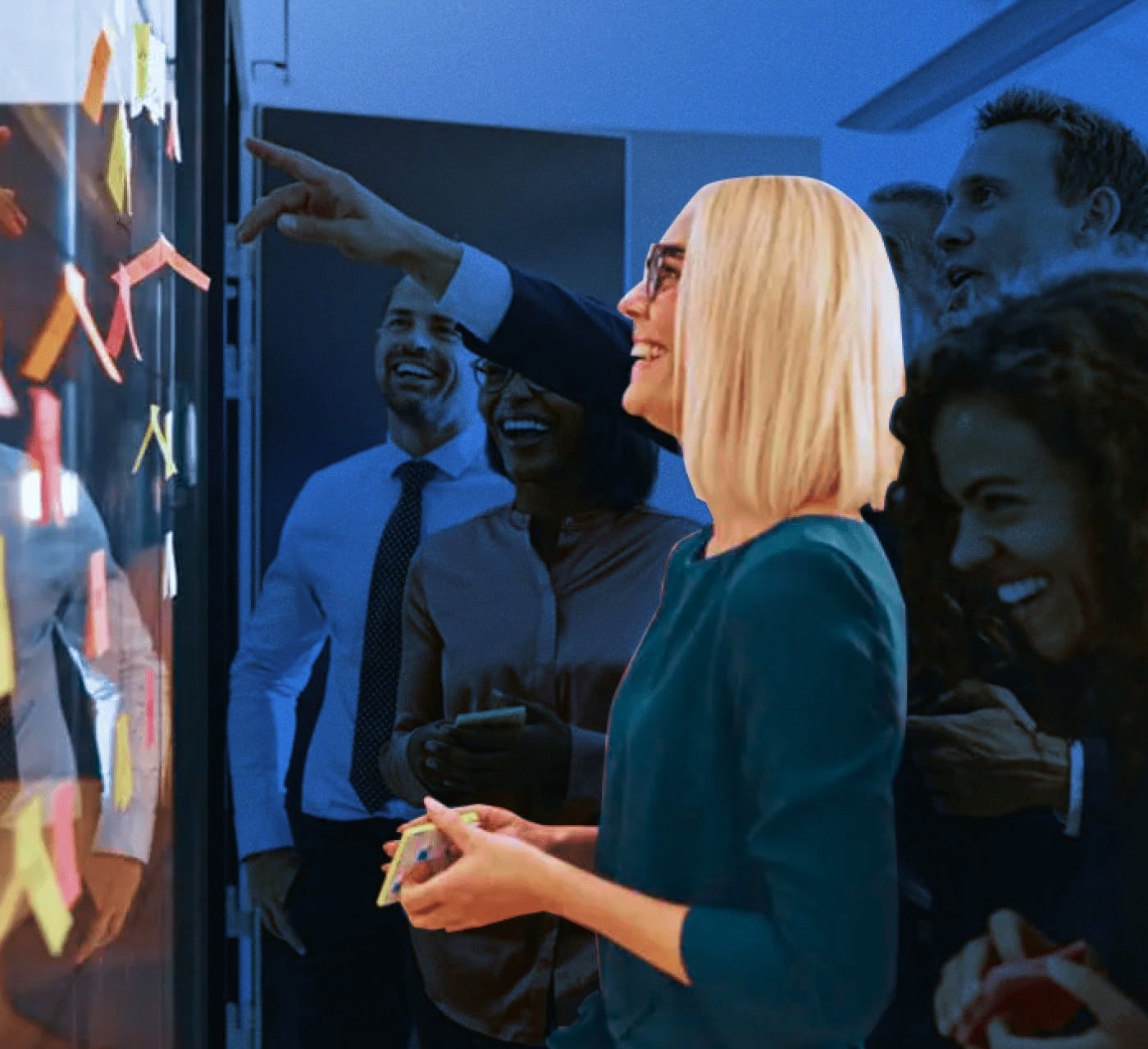 woman with her team brainstorming with sticky notes on a blue background
