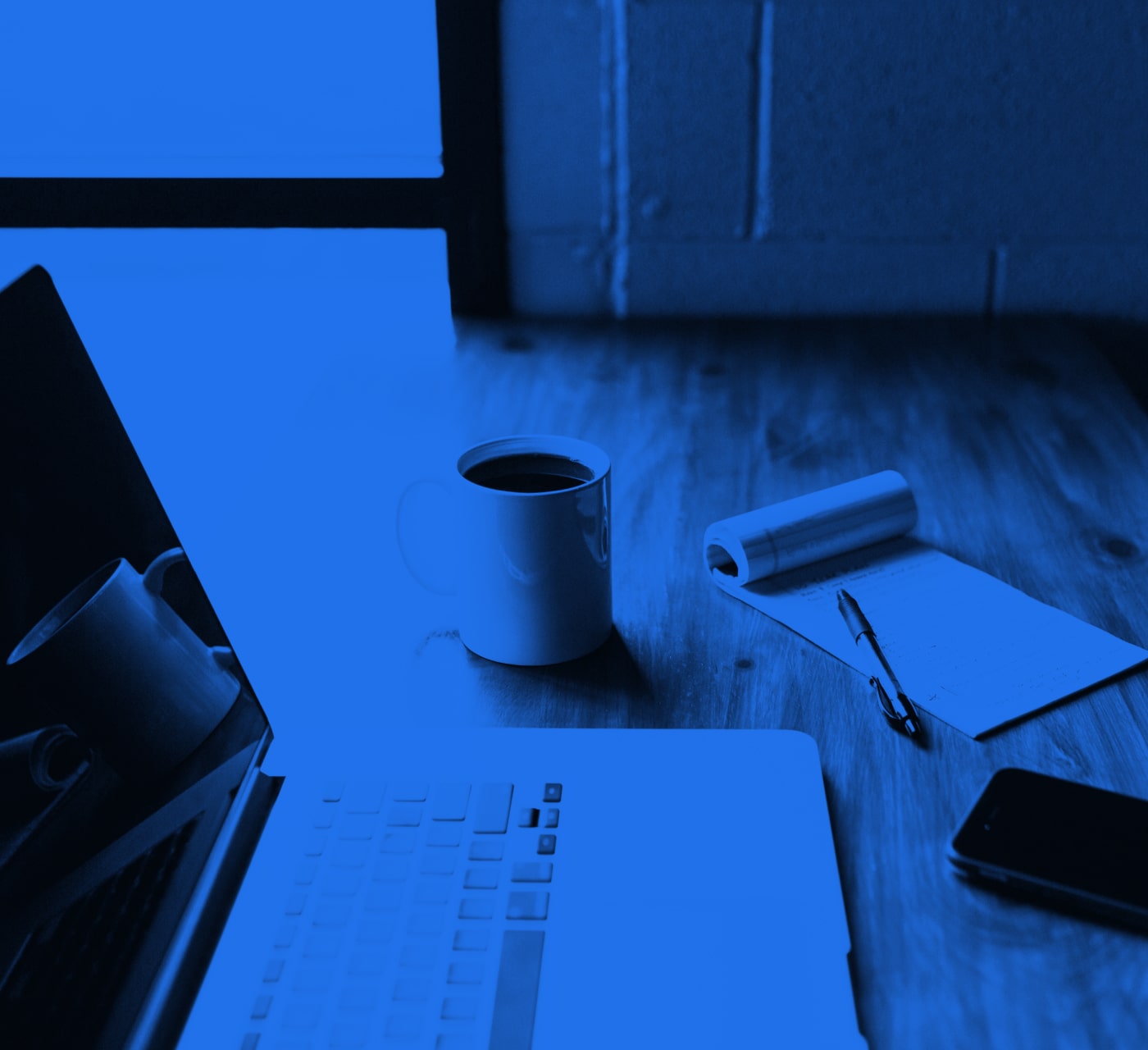 table setting with coffee mug and laptop searching dam vs video hosting