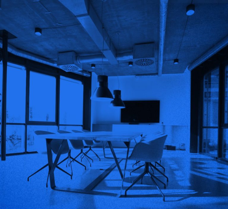Board room set up with desk and chairs ready for team to discuss interactive brand guidelines
