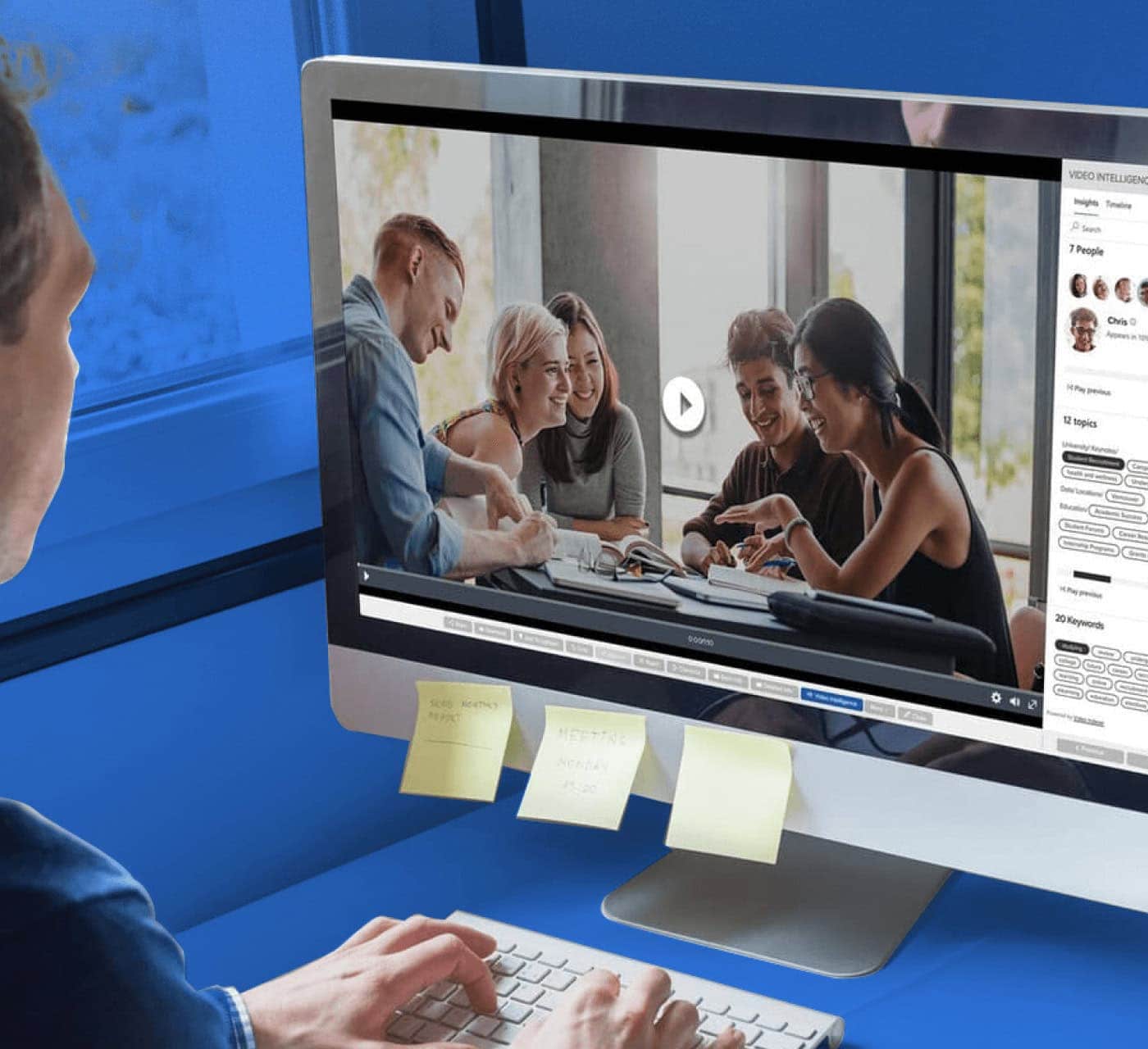man on his computer using MediaValet's audio video intelligence on a blue background