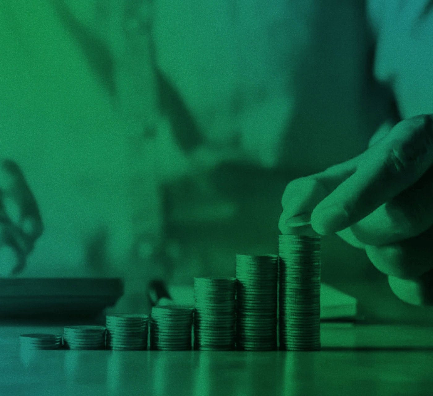 green blue gradient image of a close of a hand stacking coins