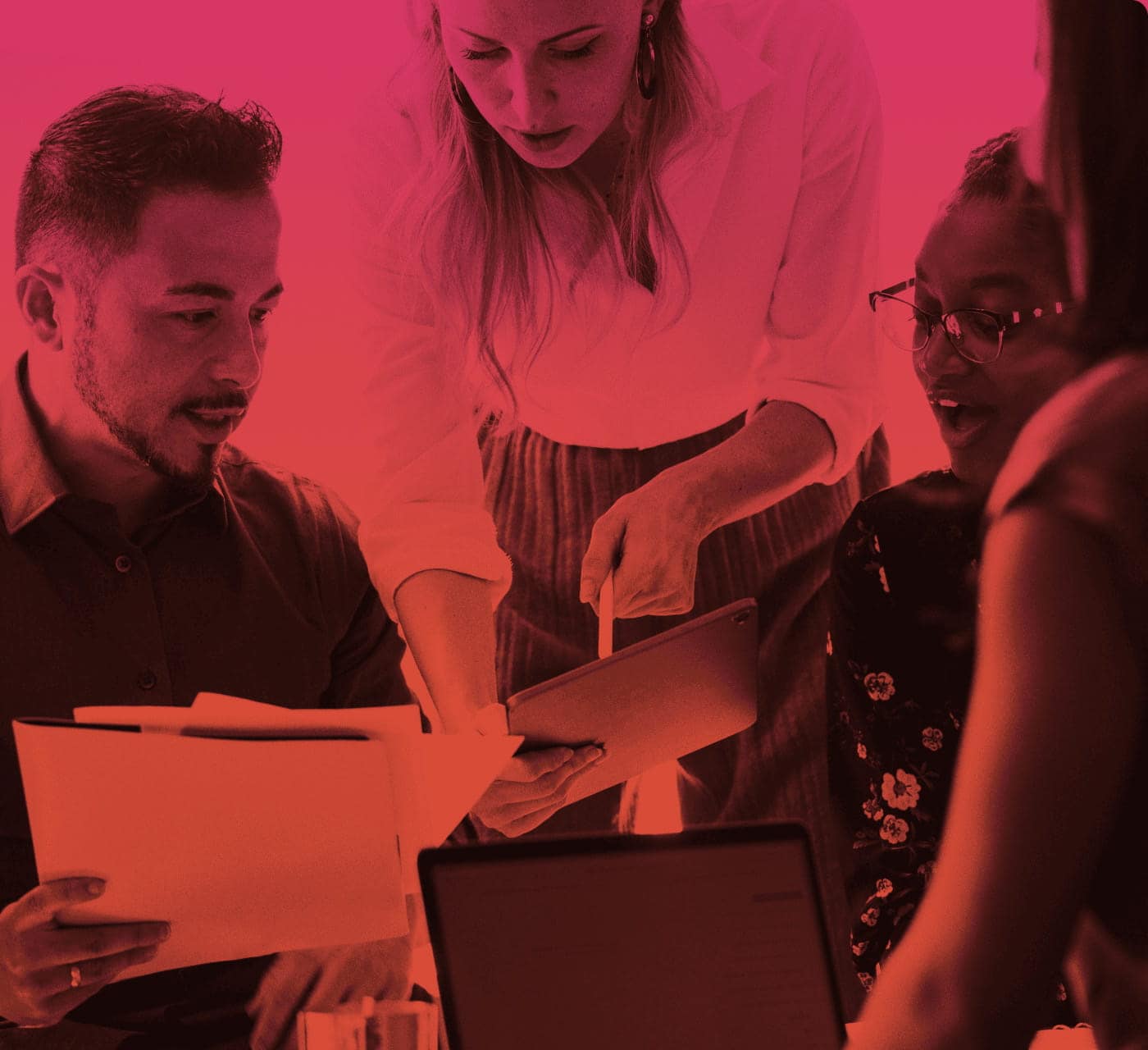 Four business people collaborating with folders and tablets