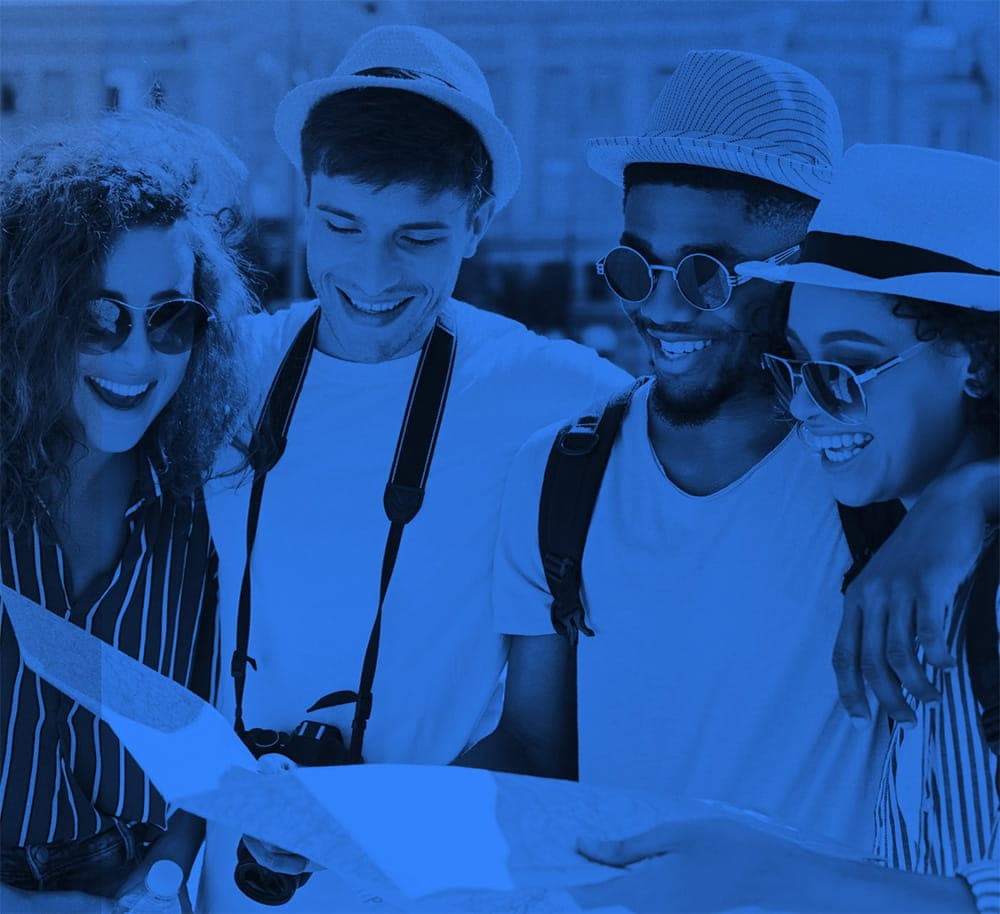 Four friends looking at a map and laughing