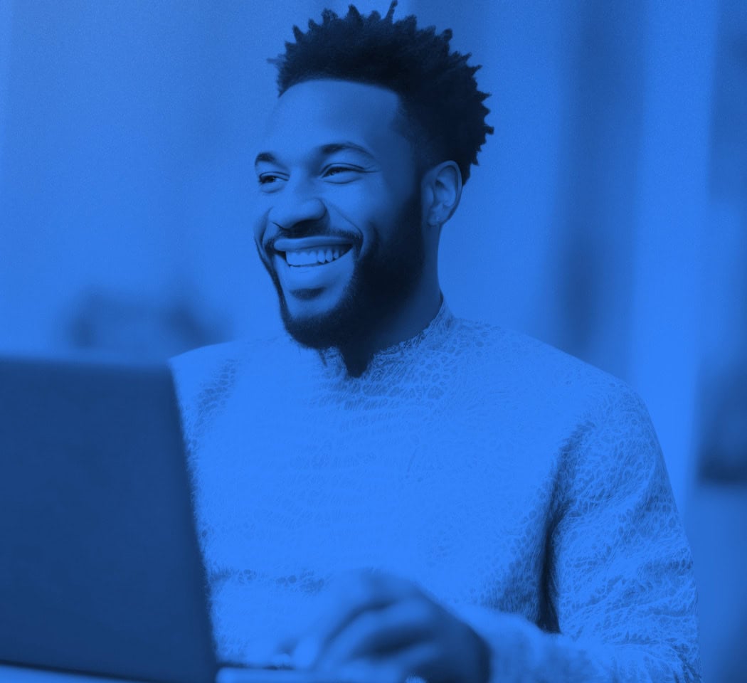 Business man smiling while working on a laptop