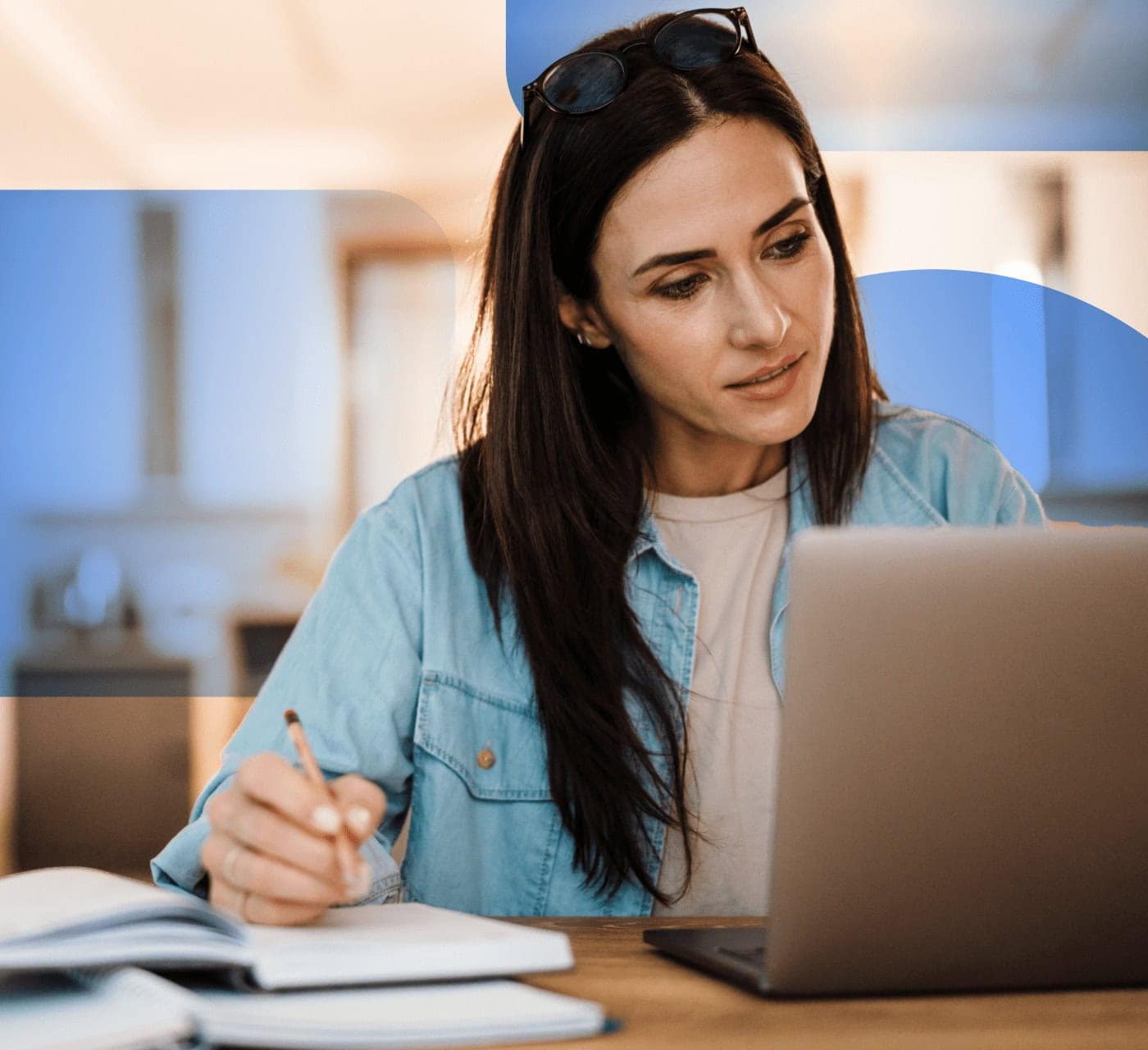 Cool woman working on a laptop taking notes