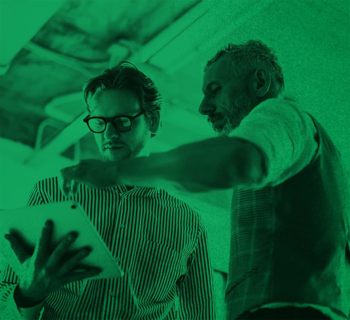 Two business men looking at an ipad